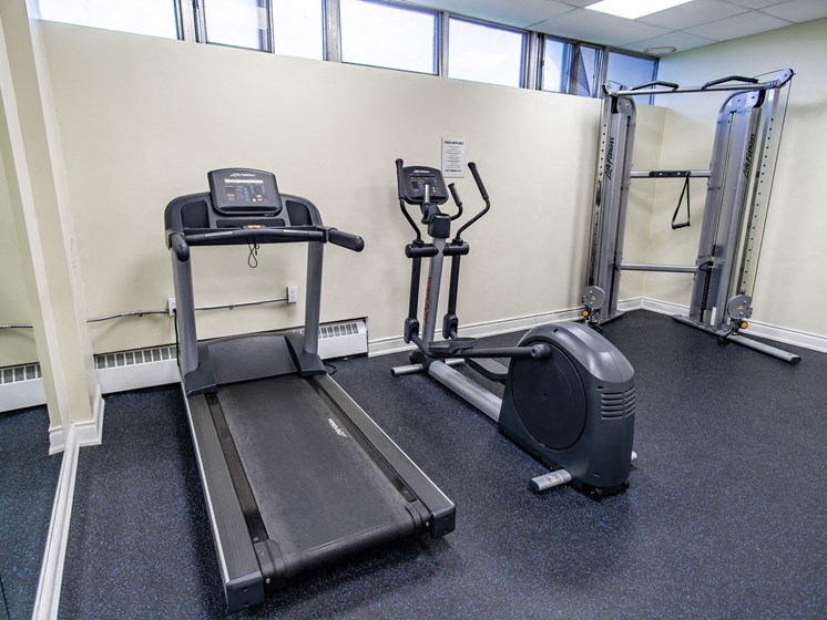 two treadmills and other exercise equipment in a gym