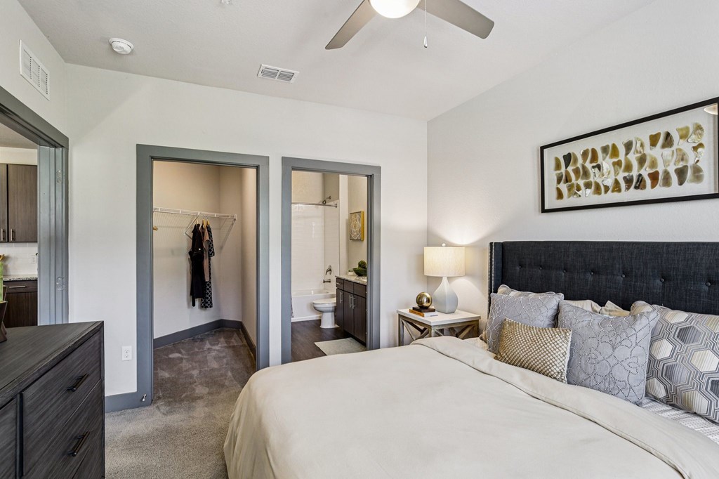 Bedroom with spacious walk-in closet and attached bathroom at Lotus at Starkey Ranch in Odessa, Florida.