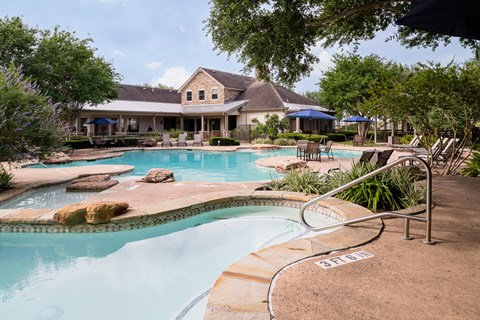 A large house with a pool and a hot tub.