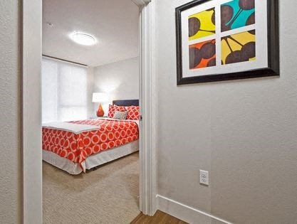 a bedroom with a bed and a painting on the wall at Astro Apartments, Seattle, WA, 98109