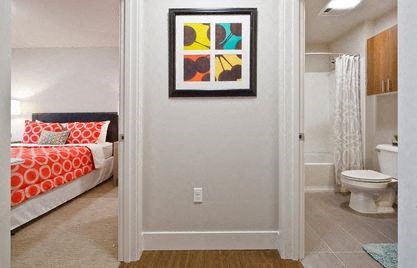 a bedroom with a bed and a toilet in a bathroom at Astro Apartments, Washington, 98109