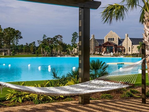 Pet-Friendly Homes for Rent in Humble, TX - Edgewater at the Lagoon - Pool with a Hammock in Shaded Area, and Beautiful Landscaping