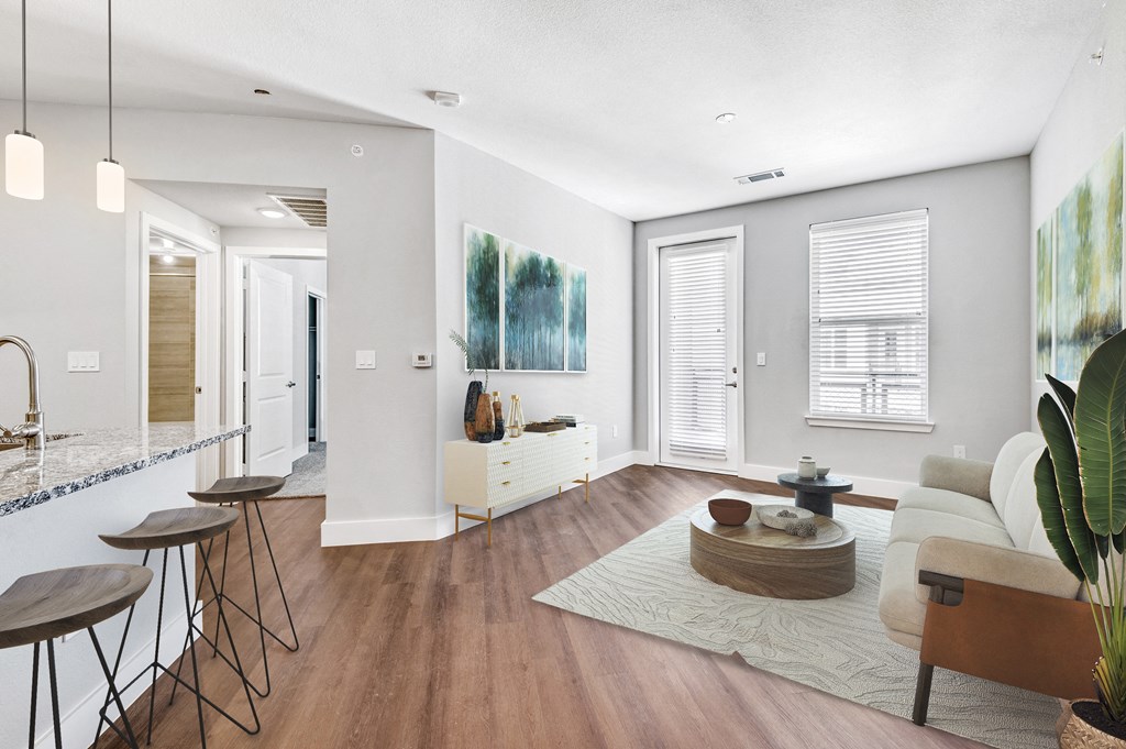 a living room with white walls and wooden floors and a white couch