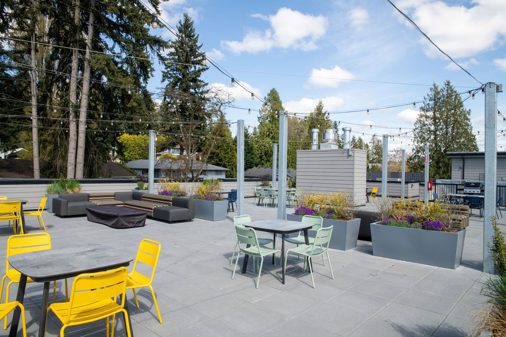 an outdoor patio with tables and chairs and plants