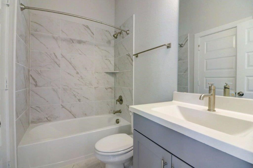a bathroom with a sink toilet and a tub