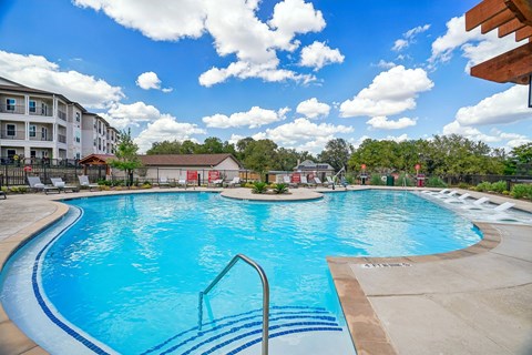 A large swimming pool with a blue tinted water and a white line on the side.