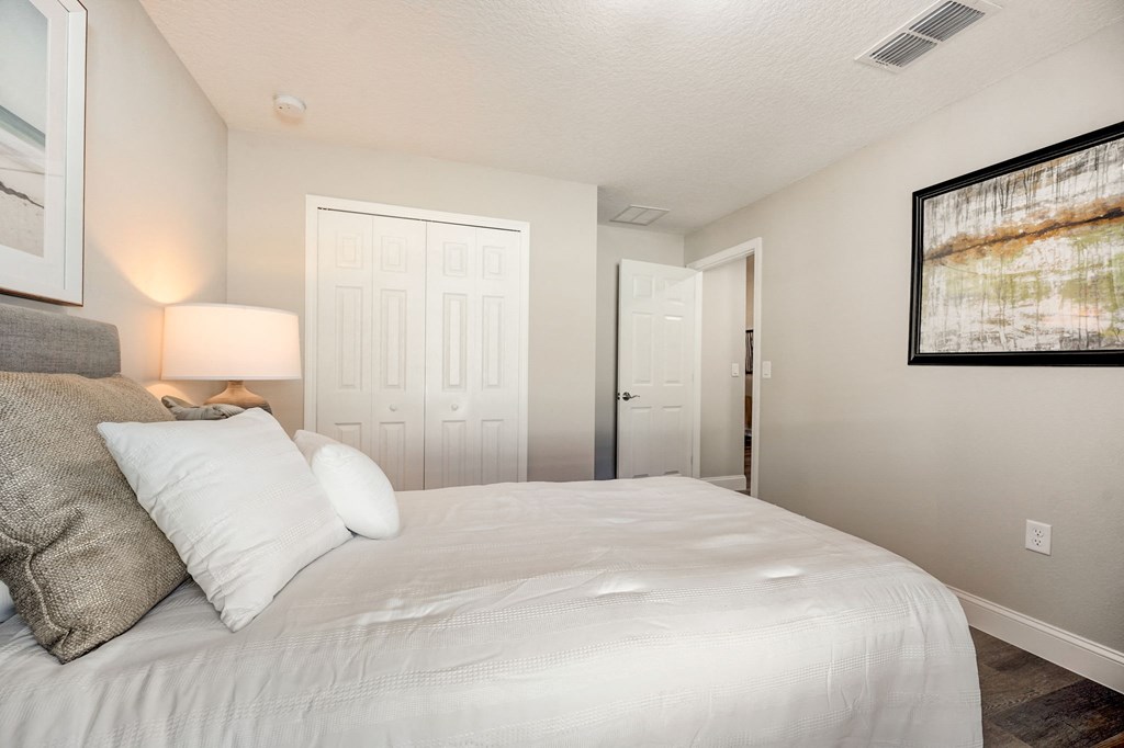 Guest bedroom with a closet at The Groves at Lake Ella in Lady Lake, Florida, a pet-friendly rental community.