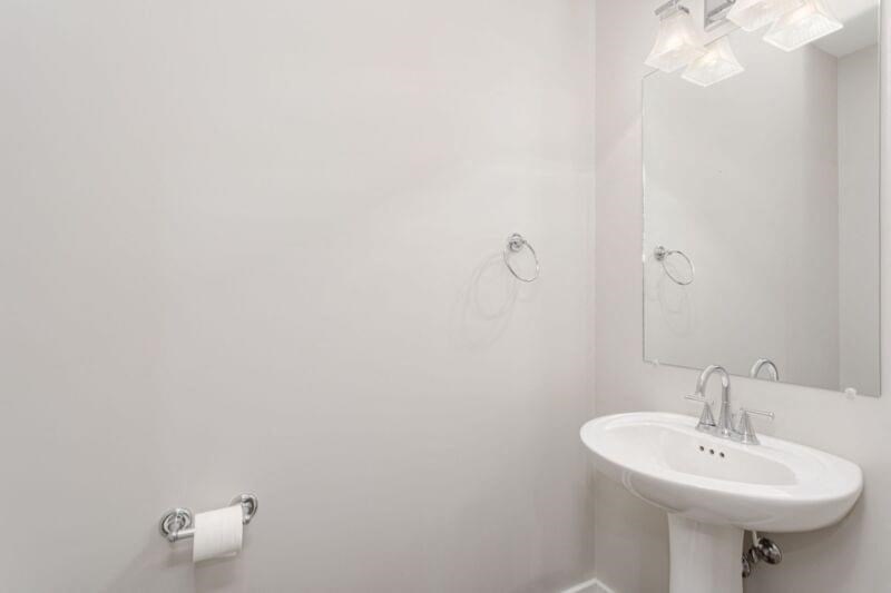 a white bathroom with a sink and a mirror