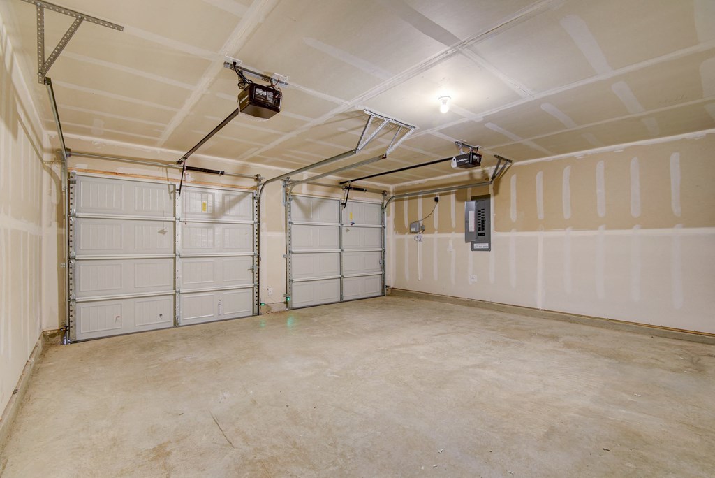the interior of a garage with white walls and doors