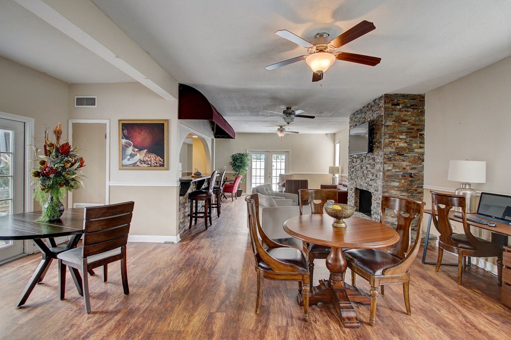 Derby Park Apartments in Daytona Beach, FL photo of a living room with a dining room table and a fireplace