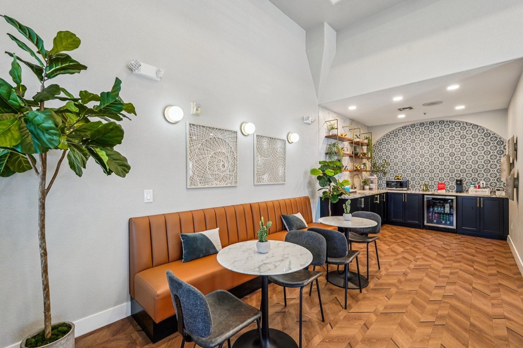 A dining area with a round table and chairs.