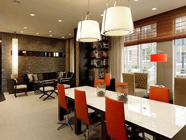 Conference table with office chairs and couch in the background