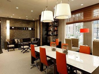 a conference room with a long table and orange chairs