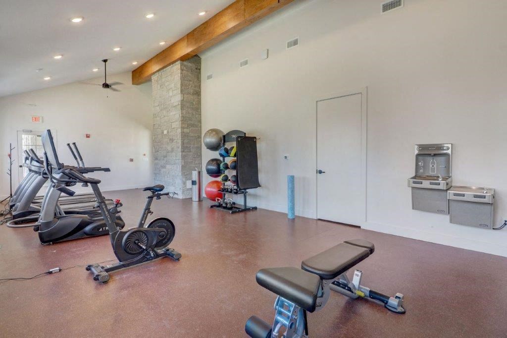 a workout room with weights and other exercise equipment in a home