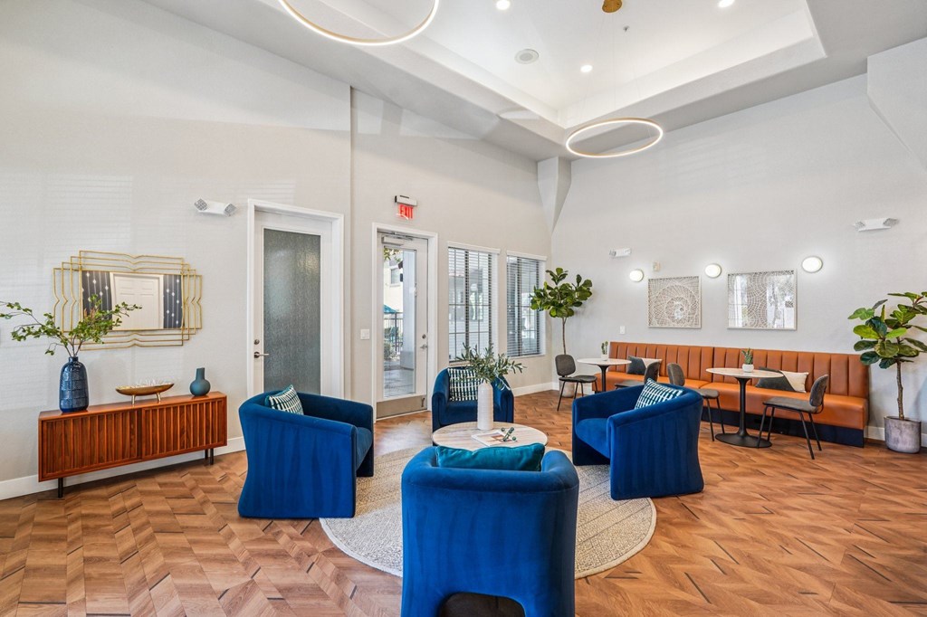 A room with blue chairs and a wooden bench.