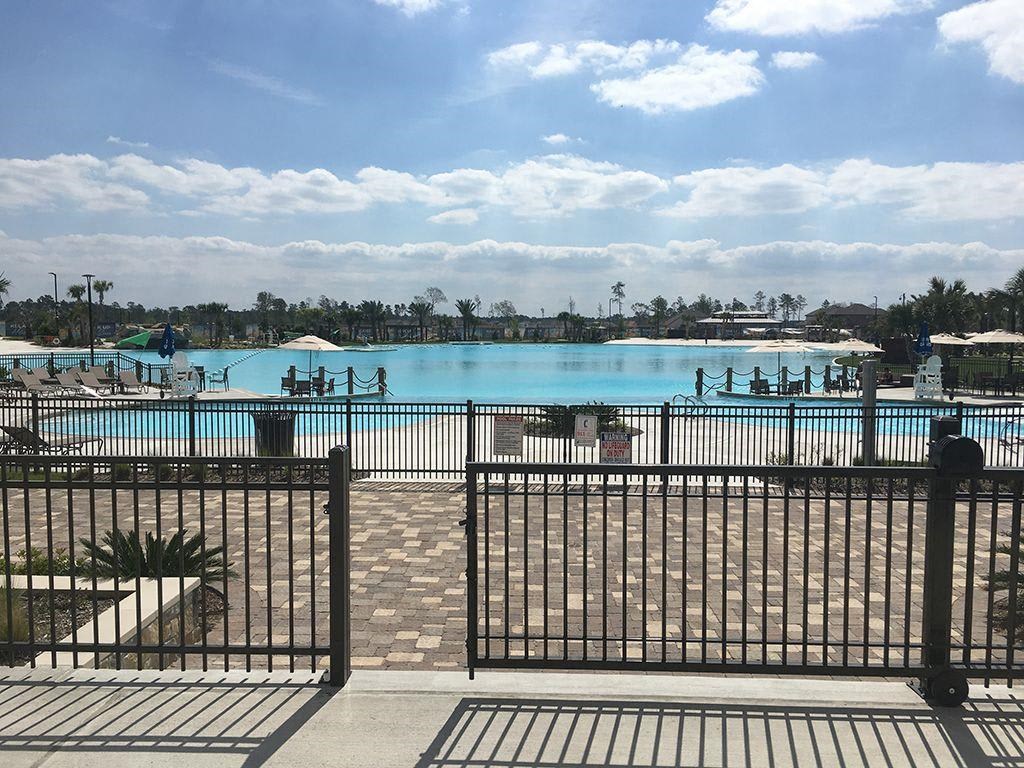 a view of a pool from behind a fence