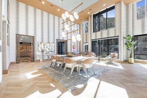 A large, modern dining room with a long table and chairs.