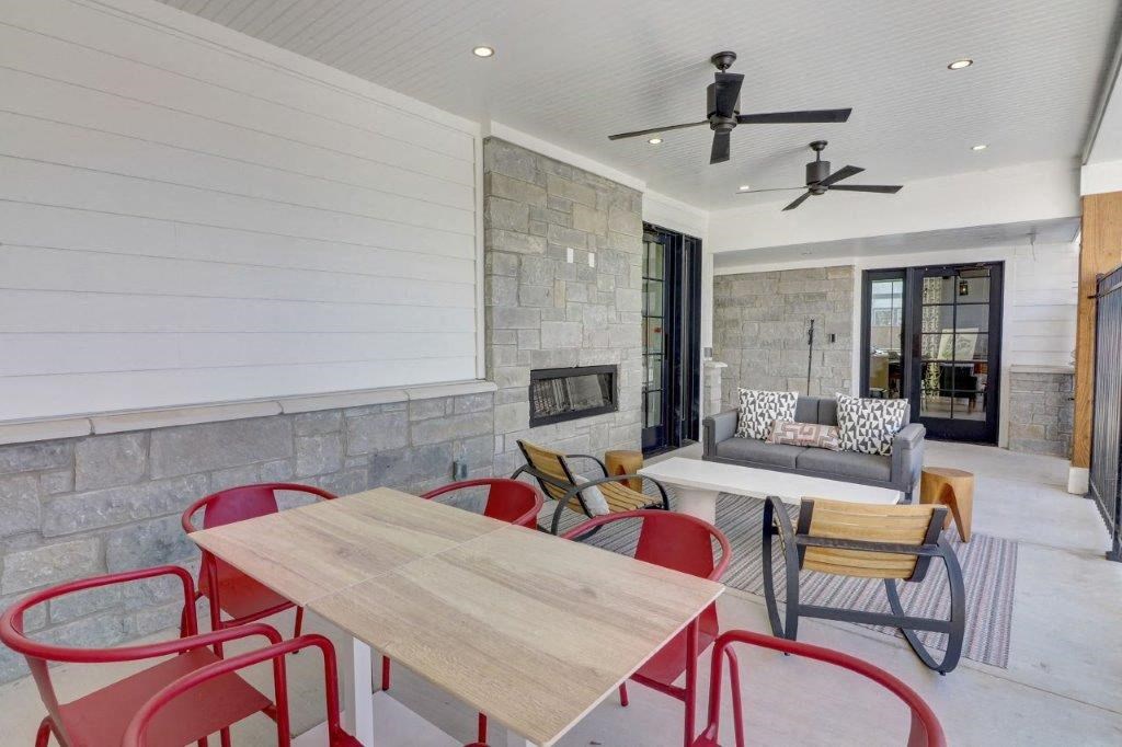 a living room with a table and chairs and a fireplace