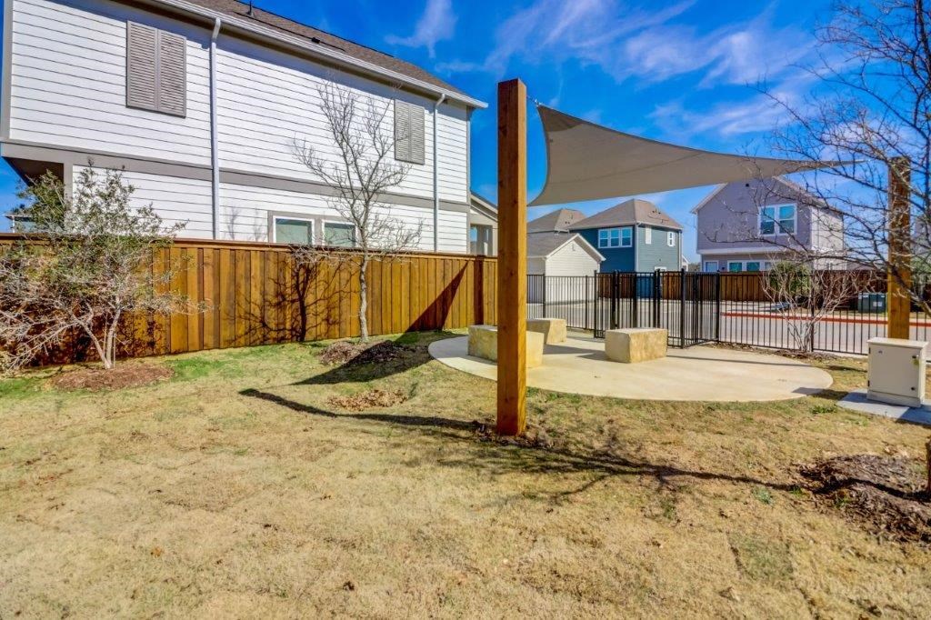 the backyard of a house with a patio with a canopy