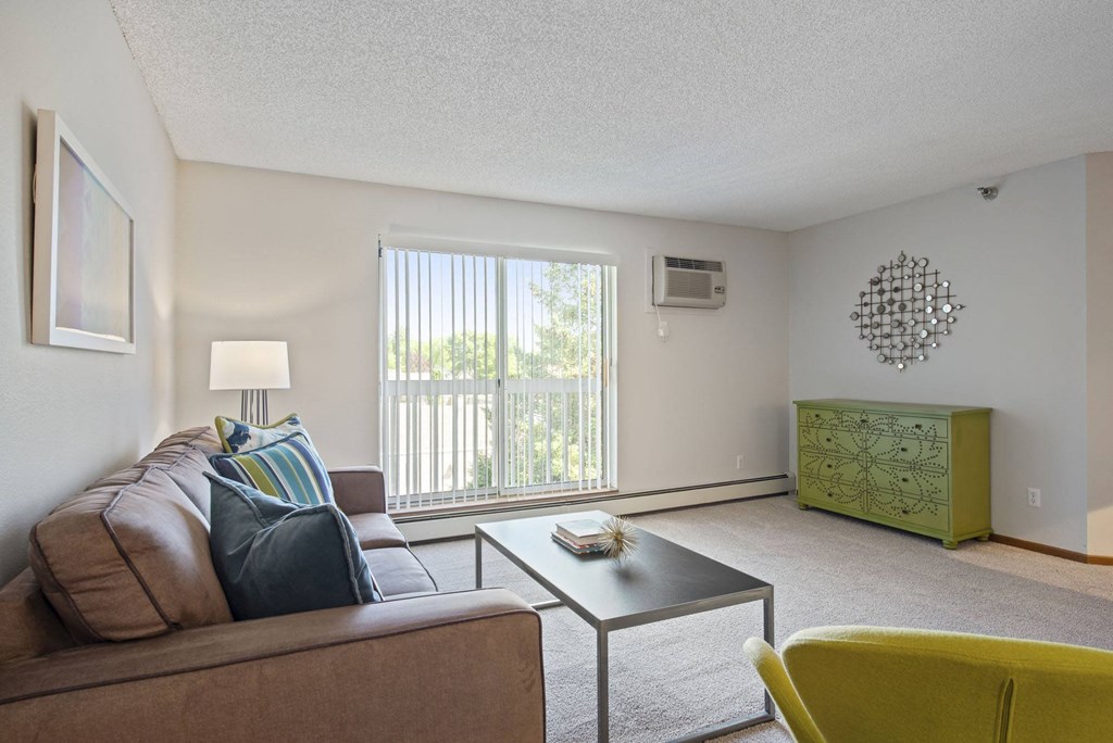the living room of an apartment with a couch and a coffee table