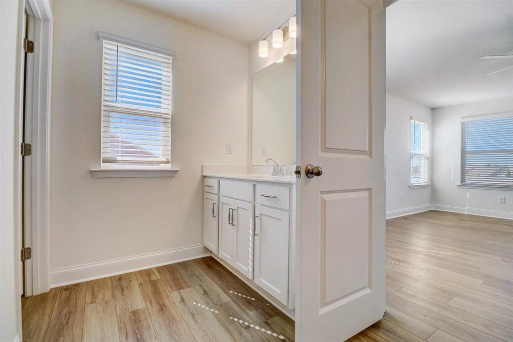 a bedroom with a bed and a mirror