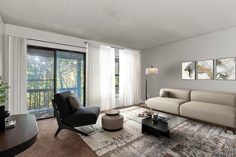 A modern living room with a black chair and a beige sofa.