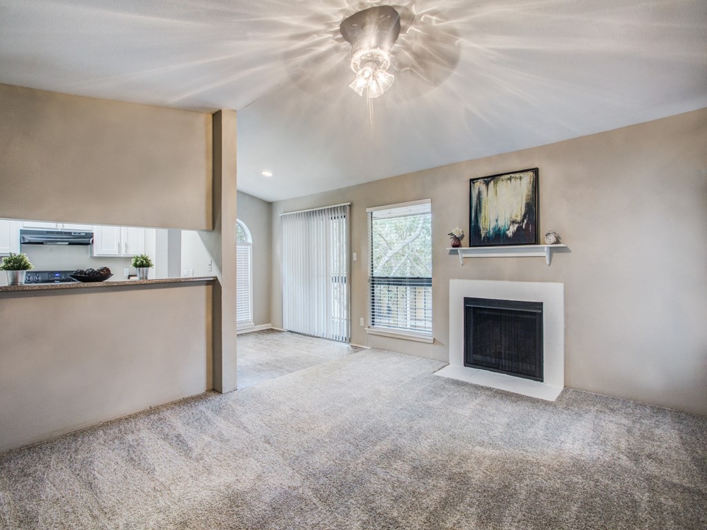 Magnolia Terrace apartments in Houston Texas 77082 photo of living room with fireplace and plush carpeting