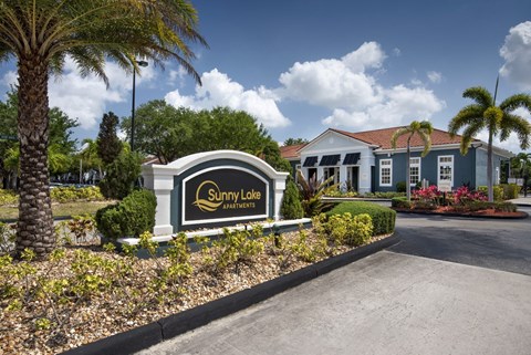 A Sunny Lake Apartments sign is in front of a building.