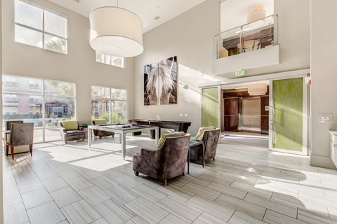 A large, modern dining room with a long table and chairs.