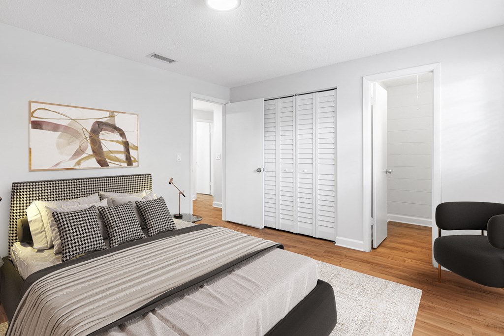 a bedroom with a bed and a chair in a 555 waverly unit