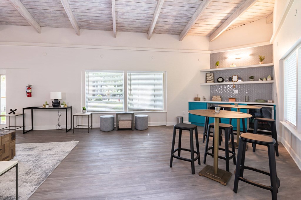 a living room filled with furniture and a large window