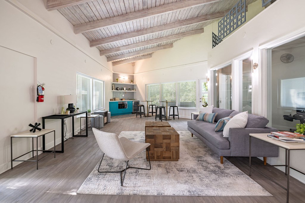 a living room with white walls and a coffered ceiling