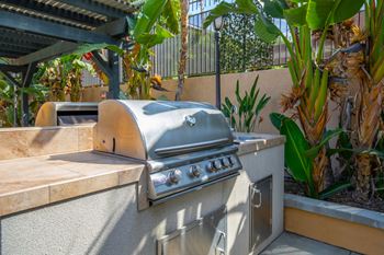 a bbq is set up in the backyard of this home for entertaining