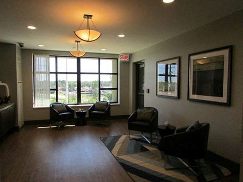 a living room with couches and chairs and a large window