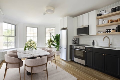 a kitchen and dining room with a table and chairs