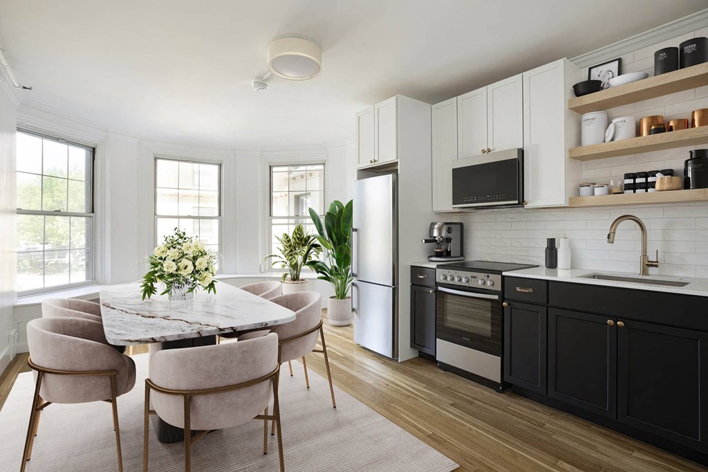 a kitchen and dining room with a table and chairs