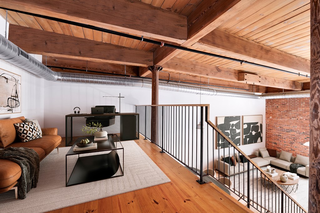 Interior view of a modern loft apartment with mezzanine level.