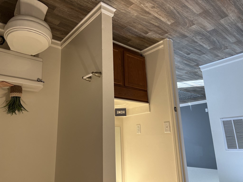 a view of the kitchen from the living room with the door open