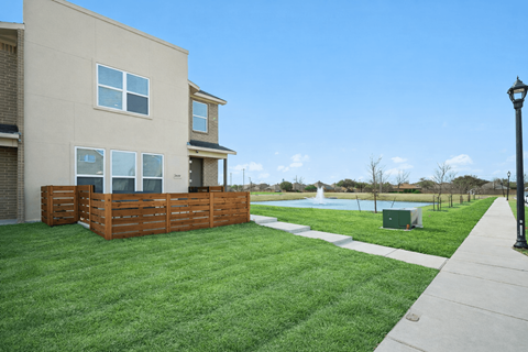 A residential building with a pool in the backyard.