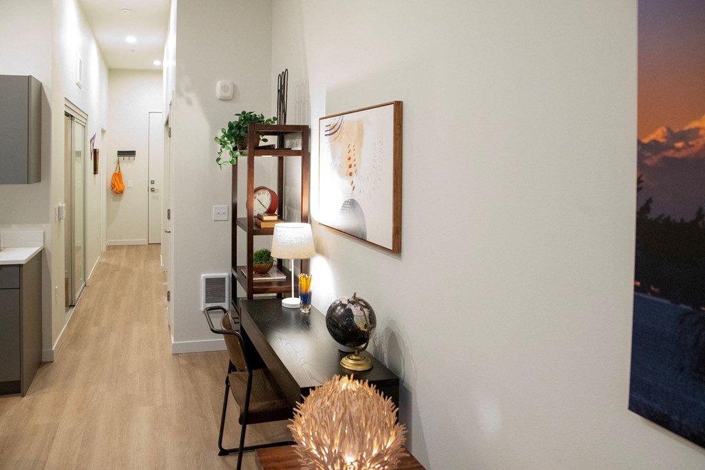 a dining room with a table and chairs and a hallway with a door