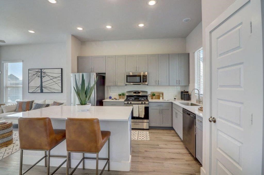 an open kitchen and living room with a table and chairs