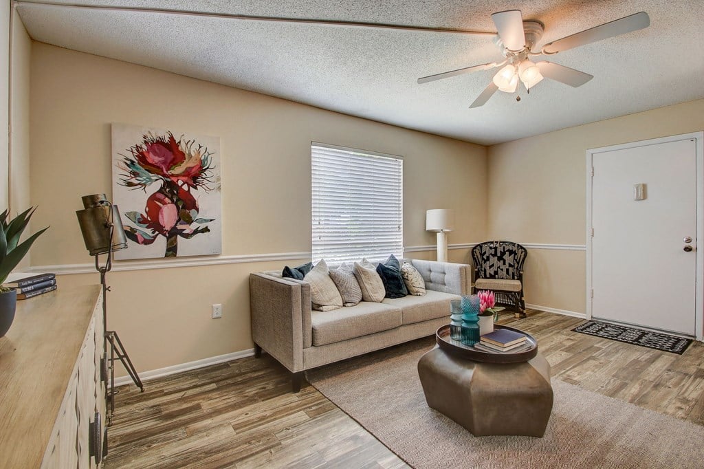 Derby Park Apartments in Daytona Beach, FL photo of a living room with a couch and a ceiling fan
