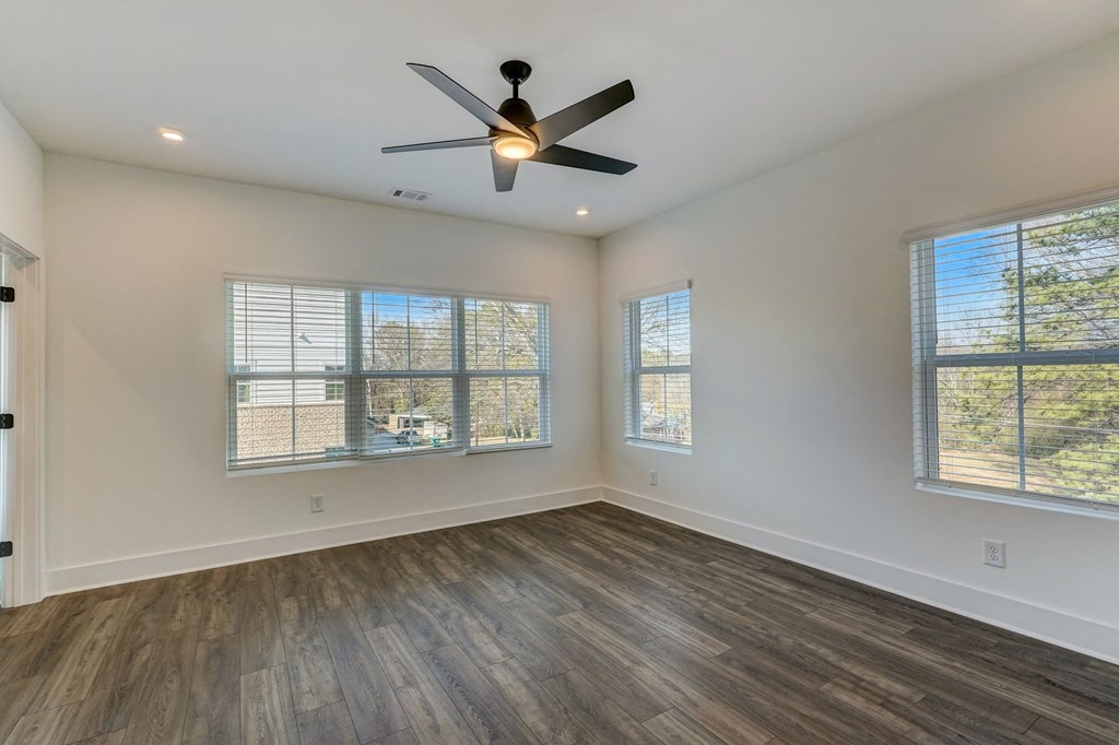 Henley Avondale Homes for rent in Avondale Estates, GA photo of an empty living room with a ceiling fan and windows