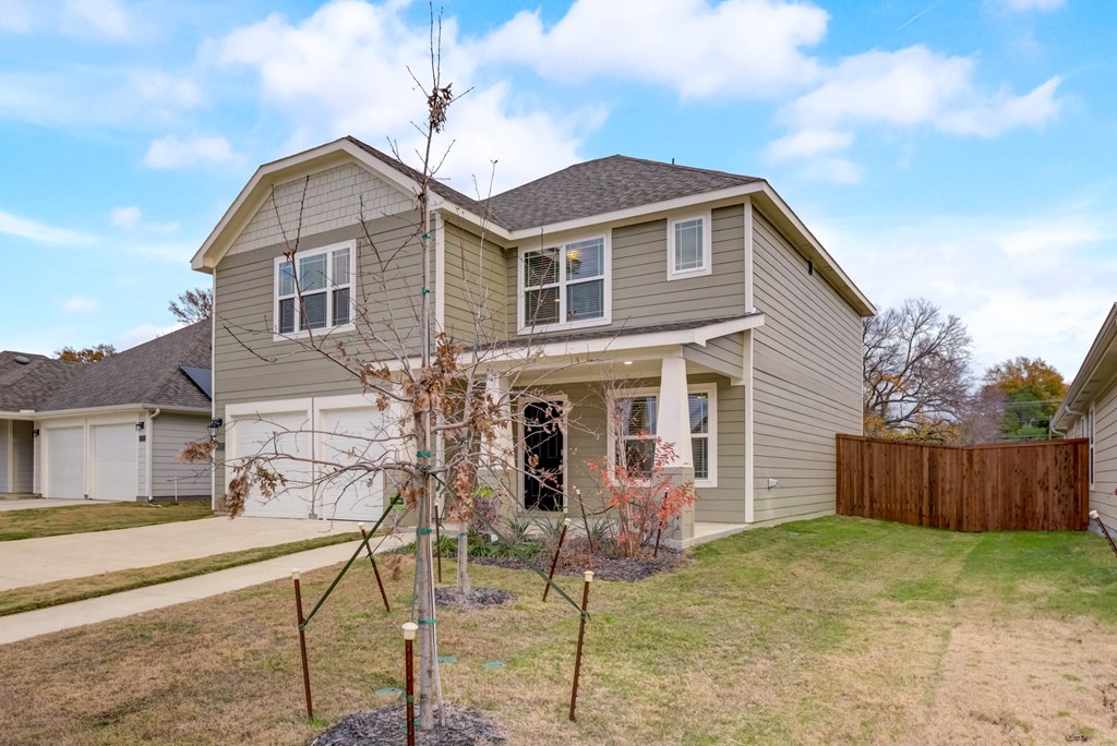 a house with a lawn and a tree in the yard