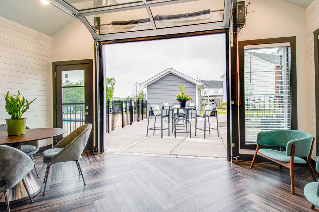 a living room with sliding glass doors to a patio with a table and chairs