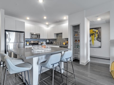 A modern kitchen with a dining table and chairs.