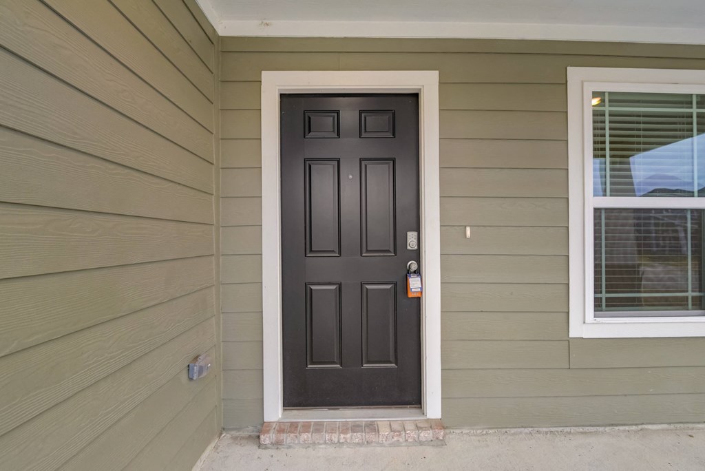 the front door of a house with a black door