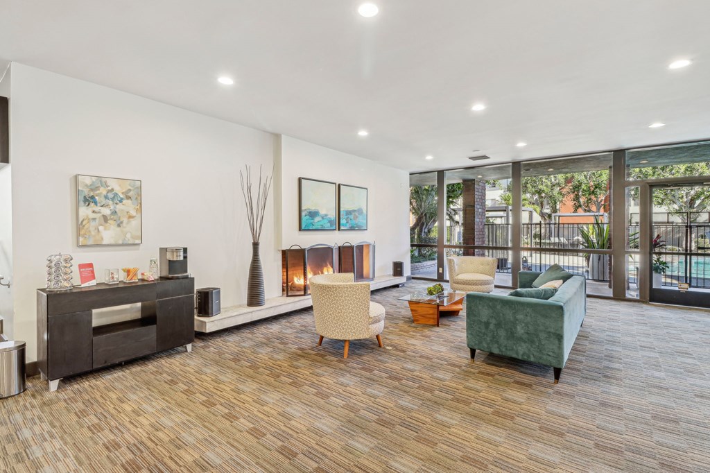 A living room with a fireplace and a green couch.