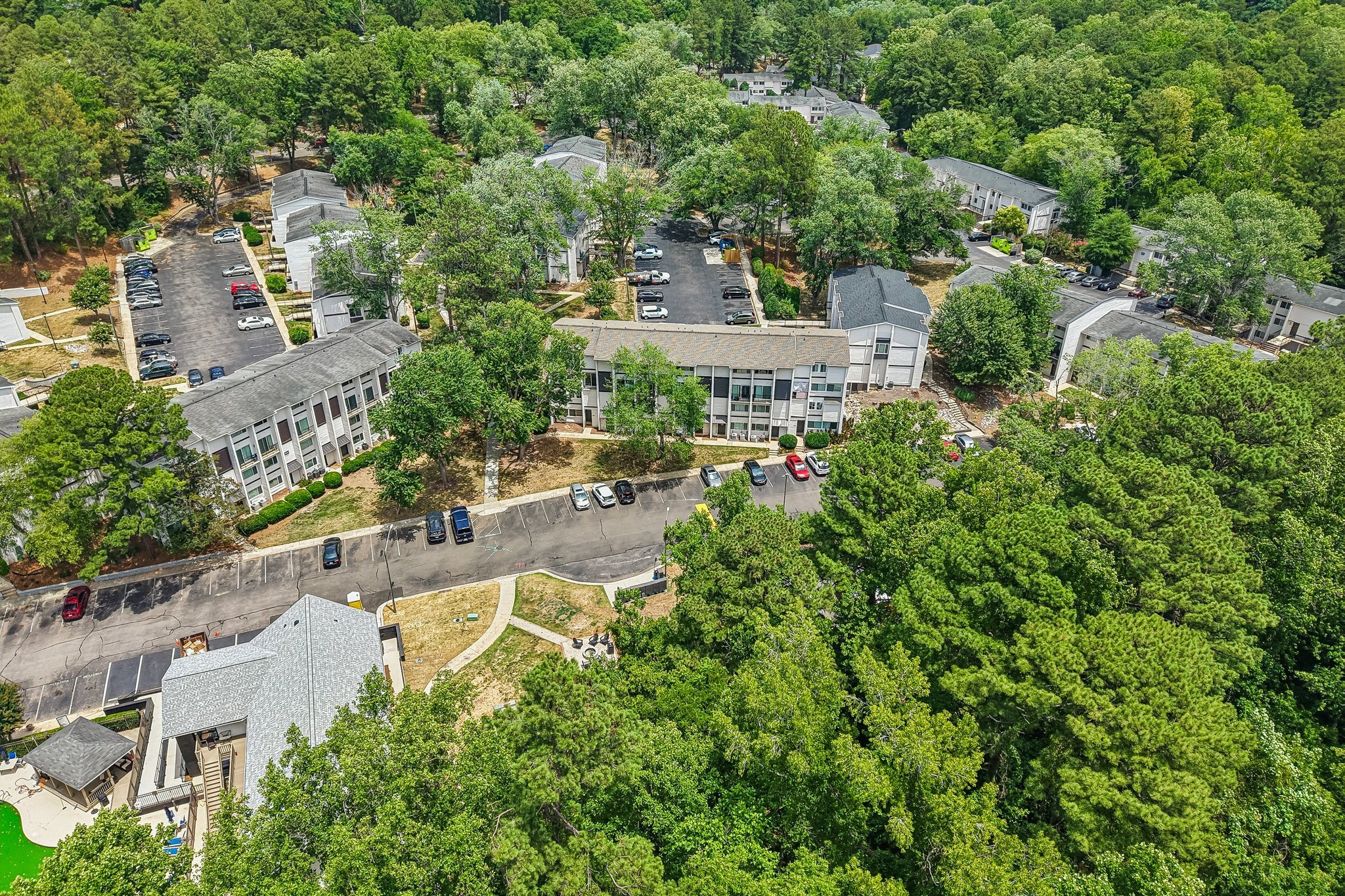 A bird's eye view of a residential area with houses and cars.