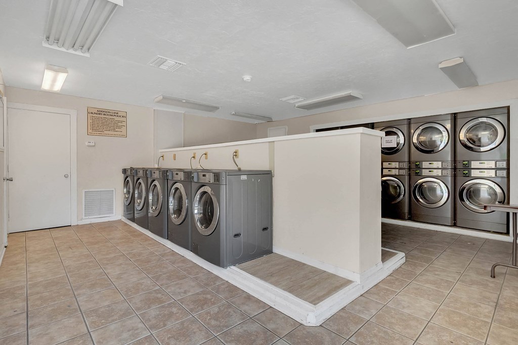 Addison Lane Apartment homes in Gainesville Florida photo of photo of washer and dryers in a laundry room